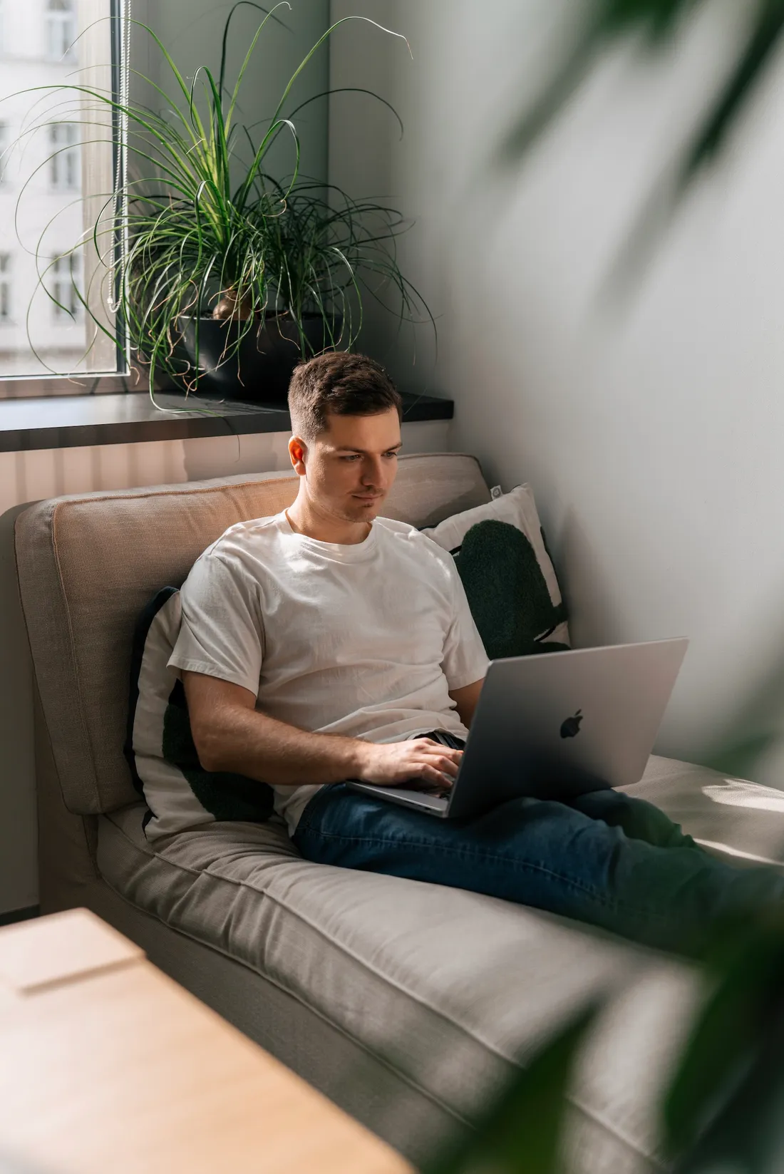 Martin Rohr working on a laptop by a sunny window